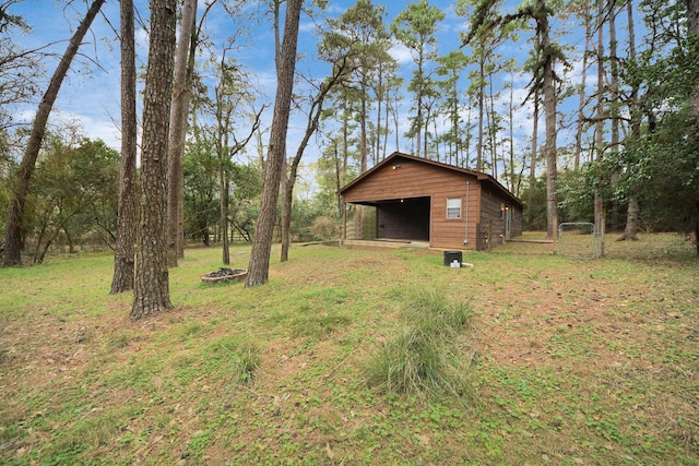 view of yard featuring an outbuilding, a pole building, and a detached garage