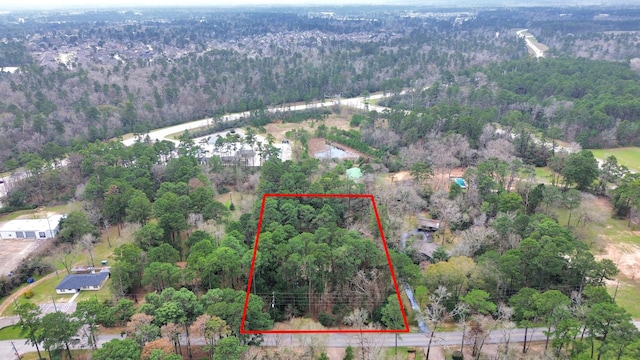 birds eye view of property featuring a wooded view