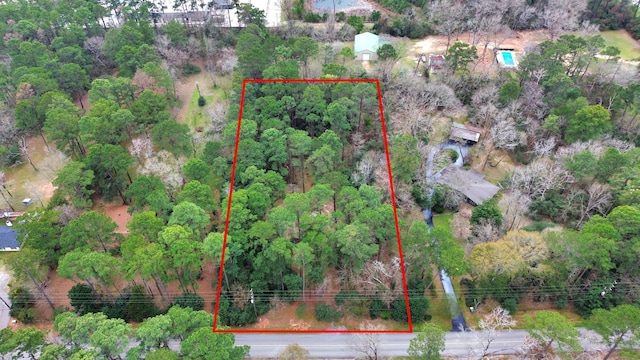 birds eye view of property with a view of trees