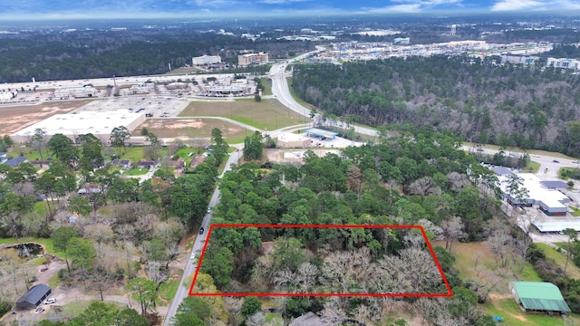 drone / aerial view featuring a view of trees