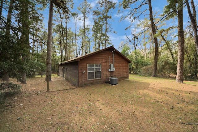 view of property exterior featuring a lawn and central AC unit