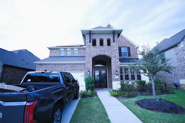 traditional home with a shingled roof, french doors, brick siding, and solar panels