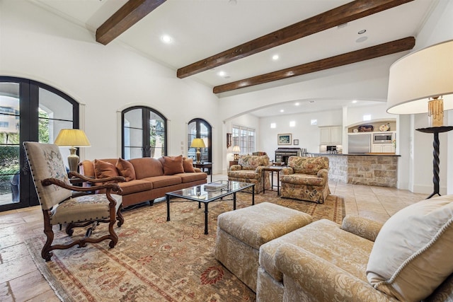 living room with arched walkways, recessed lighting, a fireplace, french doors, and beam ceiling