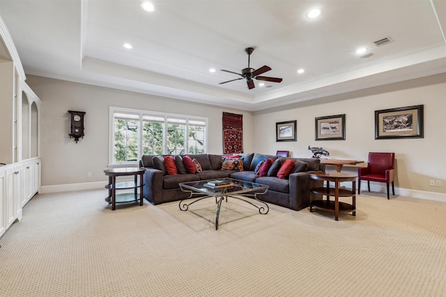 living room with recessed lighting, a raised ceiling, light colored carpet, visible vents, and baseboards