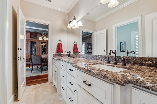 full bath featuring double vanity, a sink, visible vents, and crown molding