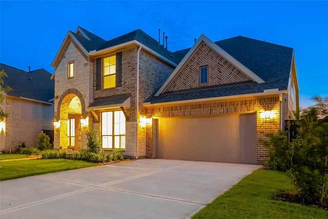 view of front of home with stone siding, a garage, brick siding, and driveway