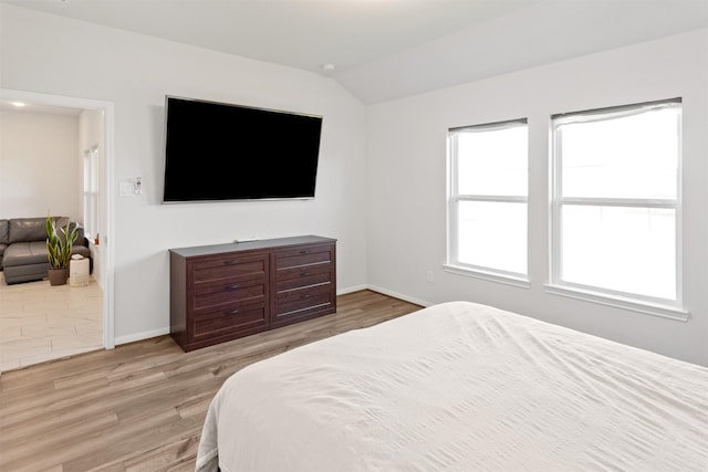 2533 Allegretto Sea Dr, Katy, TX 77493 - bedroom with lofted ceiling, light wood-style floors, and baseboards
