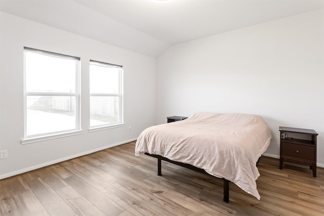 2533 Allegretto Sea Dr, Katy, TX 77493 - bedroom with baseboards, vaulted ceiling, and wood finished floors