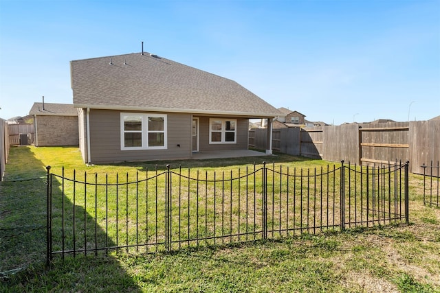 2533 Allegretto Sea Dr, Katy, TX 77493 - rear view of house with a fenced backyard, a lawn, a patio, and roof with shingles