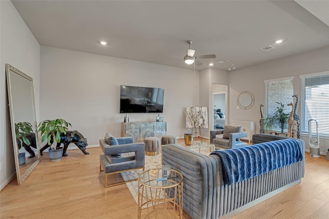 living area featuring recessed lighting, visible vents, baseboards, a ceiling fan, and light wood-style floors