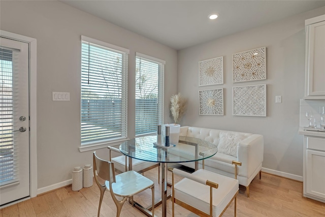 dining space with light wood-type flooring, baseboards, and recessed lighting