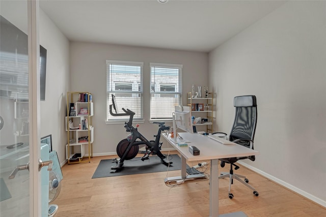 office area with light wood-style flooring and baseboards