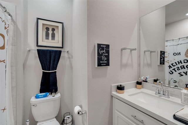 bathroom featuring toilet and vanity