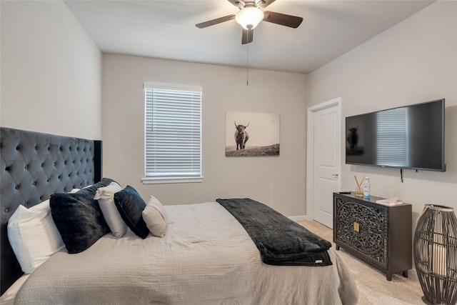 bedroom featuring light colored carpet, ceiling fan, and baseboards