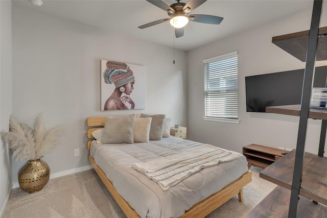 carpeted bedroom featuring ceiling fan and baseboards