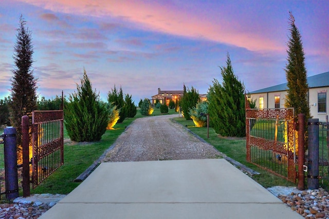 view of road with a gate, driveway, and a gated entry