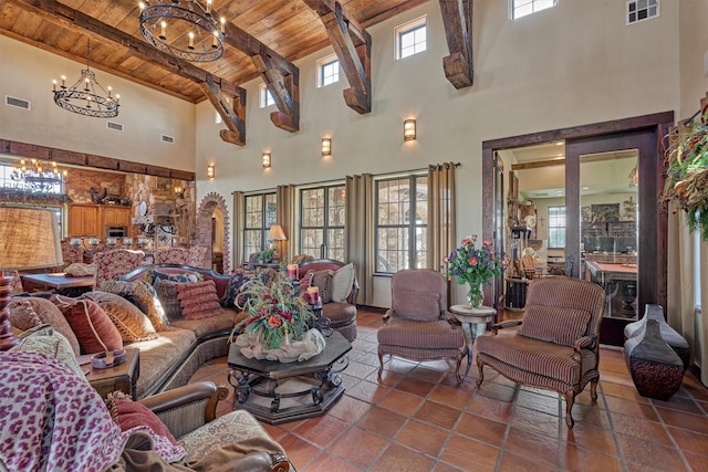 living area featuring beamed ceiling, wooden ceiling, visible vents, and a notable chandelier