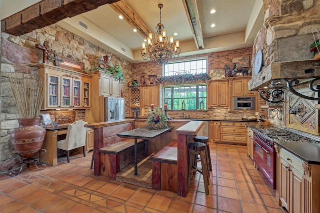 kitchen featuring visible vents, decorative backsplash, a towering ceiling, appliances with stainless steel finishes, and beamed ceiling