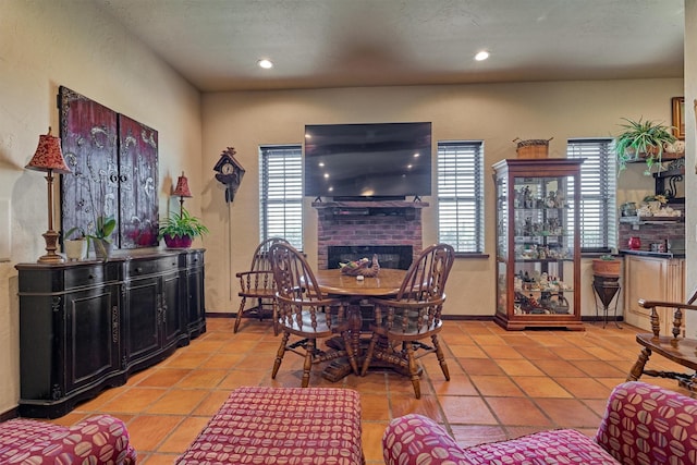 dining area featuring a brick fireplace, a wealth of natural light, and recessed lighting