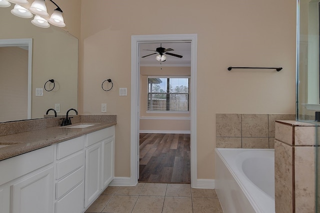 bathroom featuring a garden tub, tile patterned flooring, a sink, ornamental molding, and double vanity