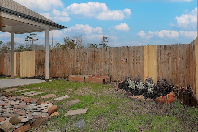 view of yard with a garden and fence