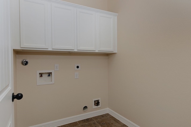 laundry room featuring cabinet space, baseboards, gas dryer hookup, hookup for a washing machine, and hookup for an electric dryer