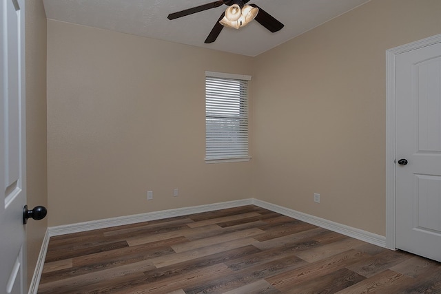 empty room with ceiling fan, baseboards, and wood finished floors