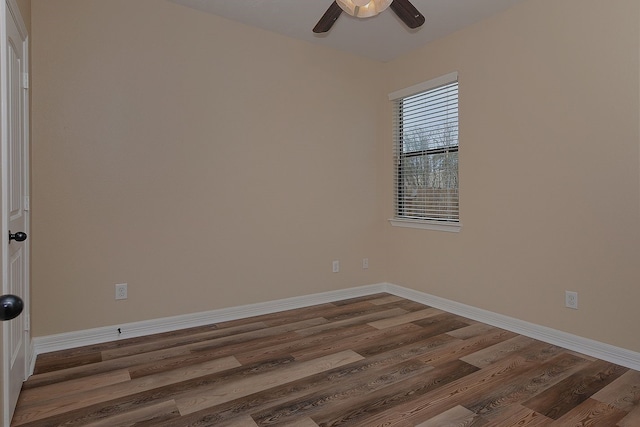 empty room with ceiling fan, baseboards, and wood finished floors