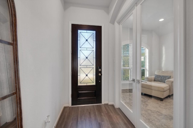 foyer with french doors, baseboards, and wood finished floors