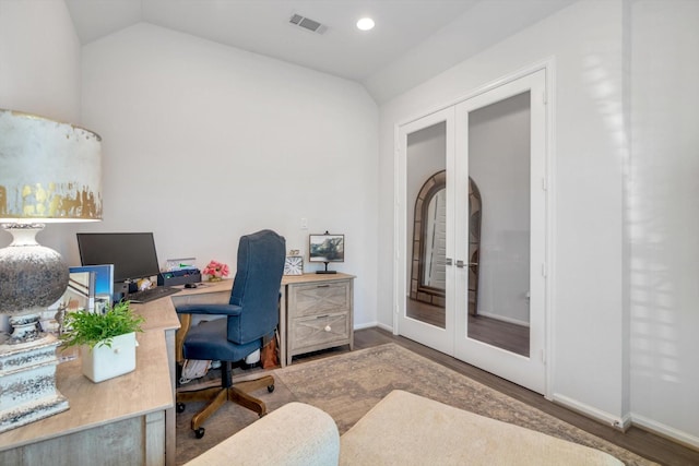 office space with visible vents, vaulted ceiling, wood finished floors, and french doors