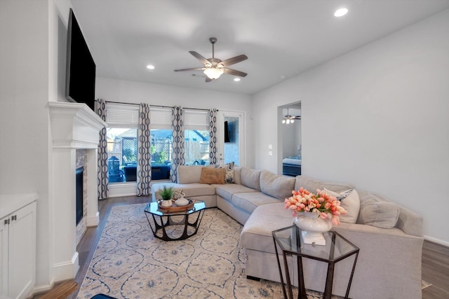 living area featuring recessed lighting, a fireplace, wood finished floors, a ceiling fan, and baseboards