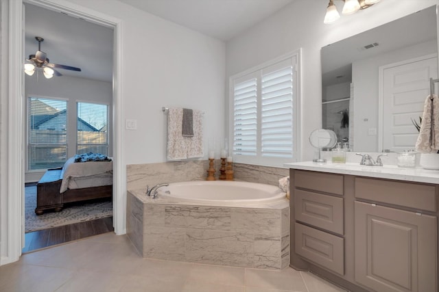 bathroom with a garden tub, tile patterned flooring, connected bathroom, vanity, and a ceiling fan