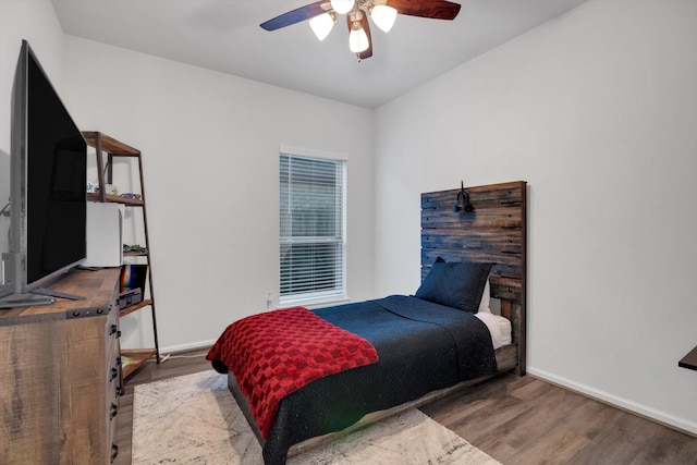 bedroom featuring light wood-type flooring, ceiling fan, and baseboards