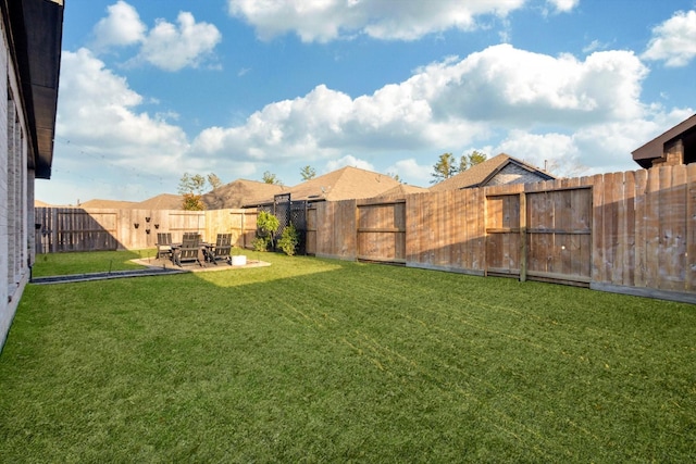 view of yard featuring a patio area and a fenced backyard