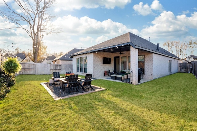 back of property featuring a patio, brick siding, a lawn, and a fenced backyard