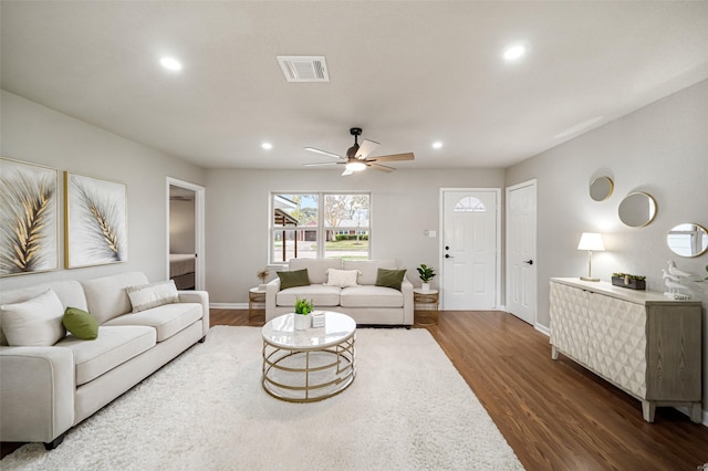 living area featuring ceiling fan, recessed lighting, visible vents, baseboards, and dark wood finished floors