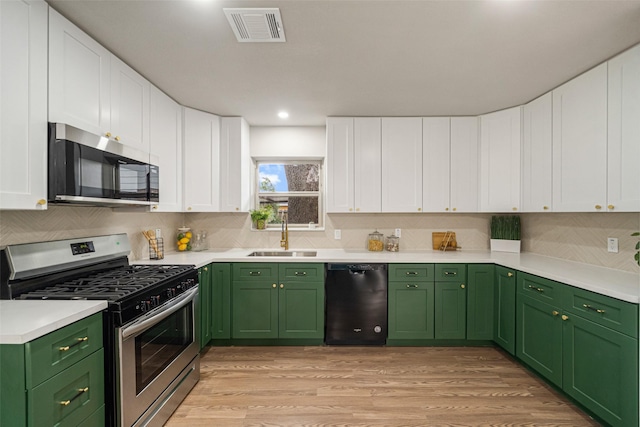 kitchen with stainless steel appliances, light countertops, visible vents, and a sink