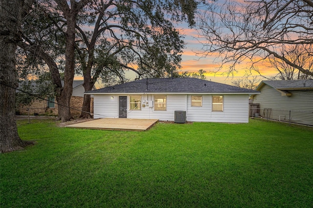 back of property with a yard, a patio area, fence, and central air condition unit