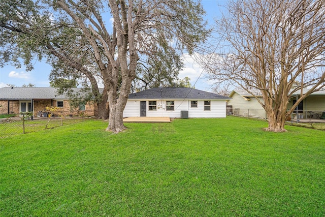 rear view of house with a fenced backyard, cooling unit, a deck, and a lawn