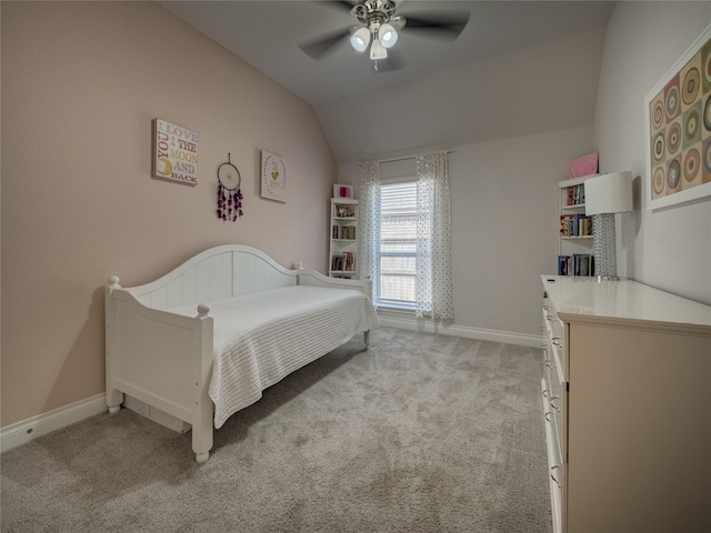 bedroom featuring baseboards, light carpet, lofted ceiling, and a ceiling fan