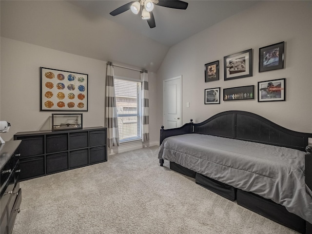 bedroom featuring baseboards, carpet floors, lofted ceiling, and a ceiling fan