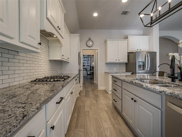 kitchen featuring a sink, visible vents, appliances with stainless steel finishes, and white cabinets