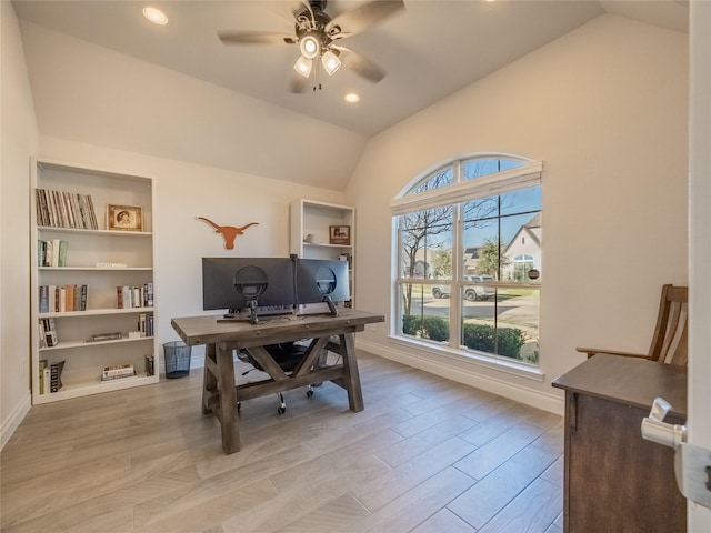 office featuring baseboards, light wood-type flooring, and lofted ceiling