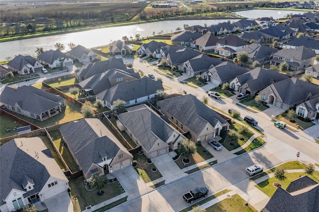 drone / aerial view with a residential view and a water view