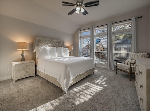 bedroom featuring light carpet, ceiling fan, baseboards, and lofted ceiling