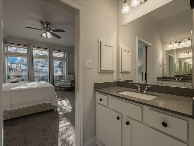 ensuite bathroom featuring connected bathroom, vanity, and ceiling fan