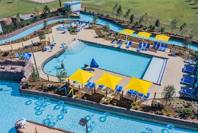 community pool with a patio and fence