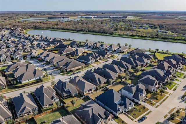 drone / aerial view featuring a residential view and a water view