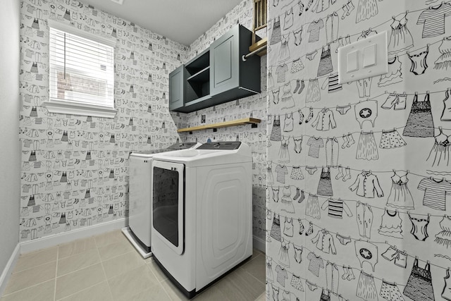 laundry area featuring light tile patterned floors, laundry area, washing machine and clothes dryer, and wallpapered walls