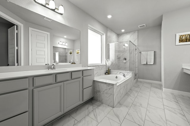 bathroom with a bath, marble finish floor, a shower stall, and visible vents